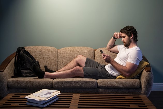 A university student experiencing financial or emotional stress at home in his apartment.