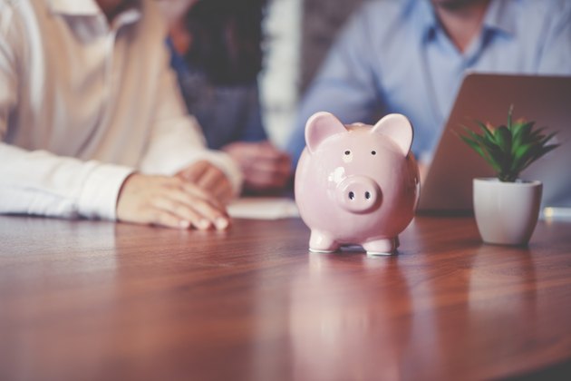 Business people with a piggy bank.