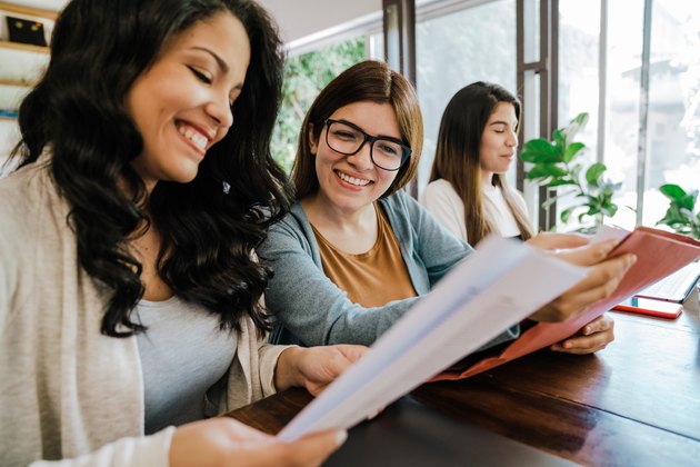 Three young adult women working together