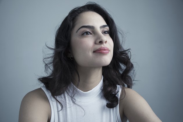 Portrait confident brunette Latina young woman looking up