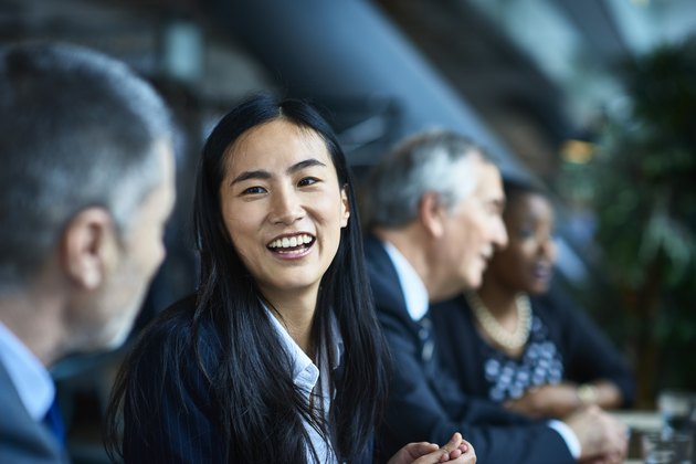 Cheerful relaxed businesswoman with manager in meeting