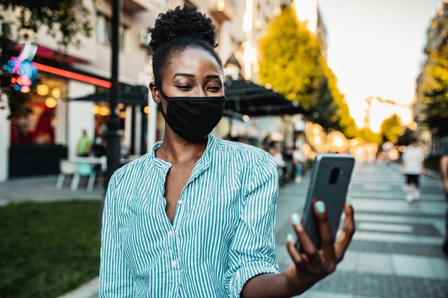Woman with a mask taking a selfie