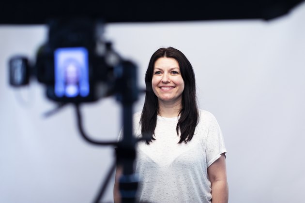 Female model standing in front of the camera at the photo studio