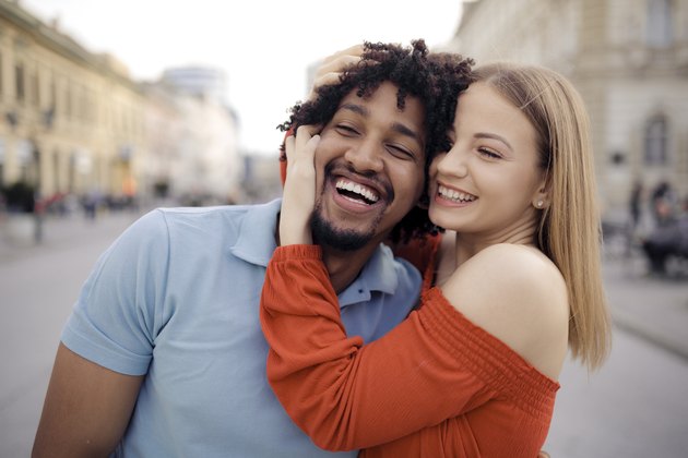 Close up of a young happy interracial couple, hugging