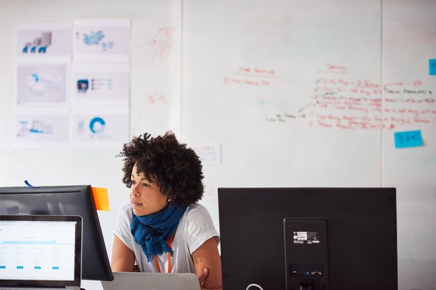Businesswoman at desk working on computer