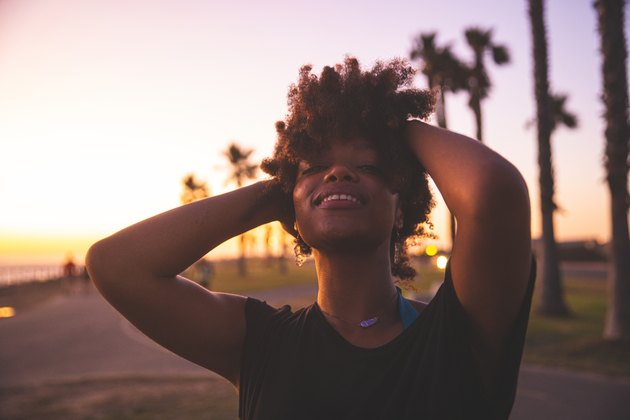 Woman enjoying the last sun of the day on a beach in California