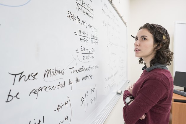 Caucasian college student reading whiteboard