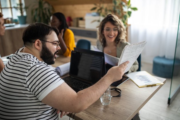 Happy business team working together at modern office