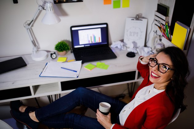 Young freelance working on laptop in home office