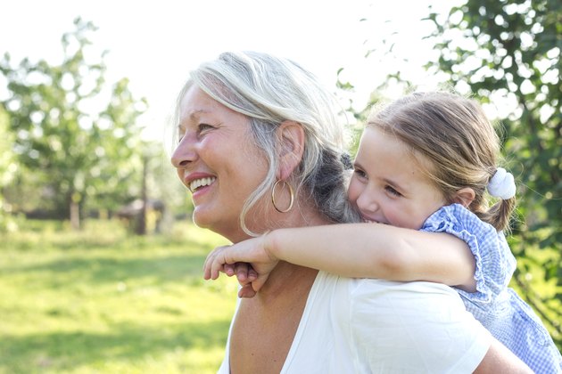 Little girl on a piggy back ride with her grandmother