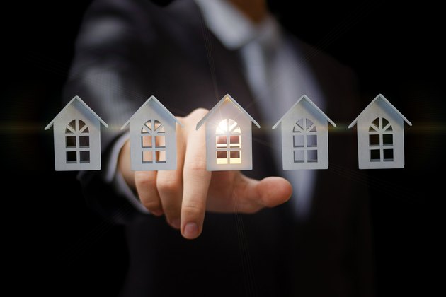 Businessman clicks on the house.