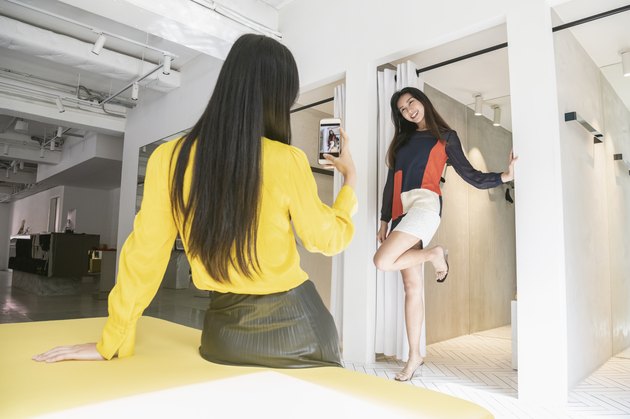 Chinese woman posing for photo by changing room