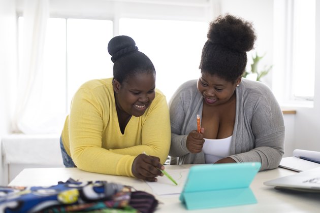 African women designing traditional clothing together