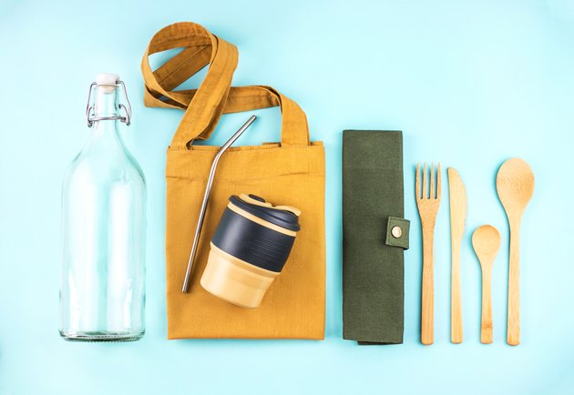 Eco bags with bamboo cutlery, reusable coffee mug and water bottle.