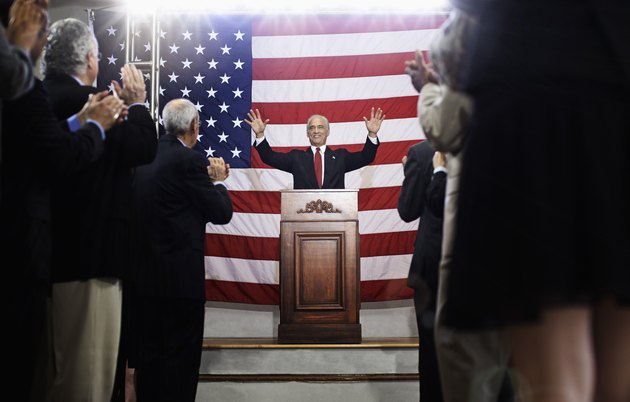 Caucasian politician making a speech at podium