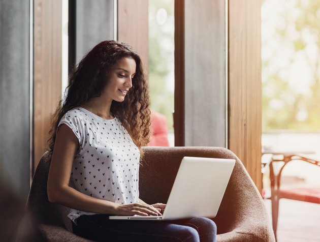 Happy girl using laptop computer