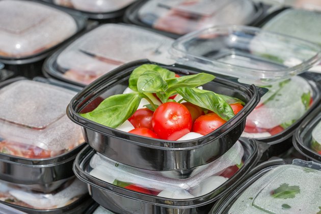 Street food box with mozzarella cheese, cherry tomatoes and basil.