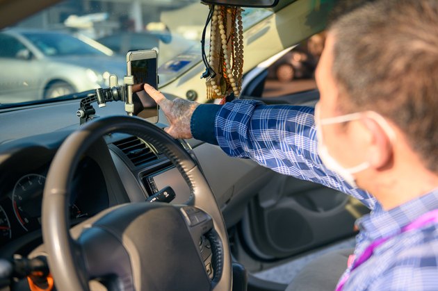 Asian male E-hailing driver with face mask get ready for ride. Uber driver