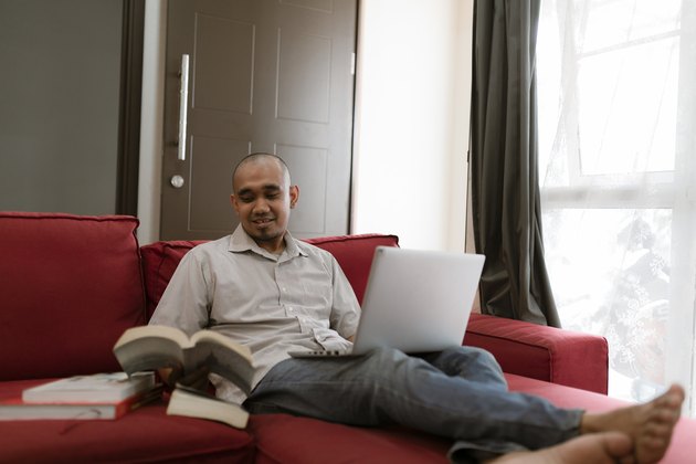 asian man working from home during coronavirus pandemic