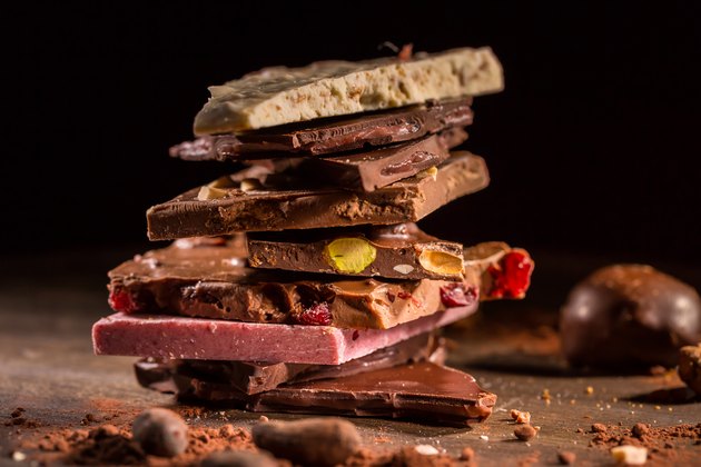 Stack of assorted chocolate with cocoa and cocoa beans