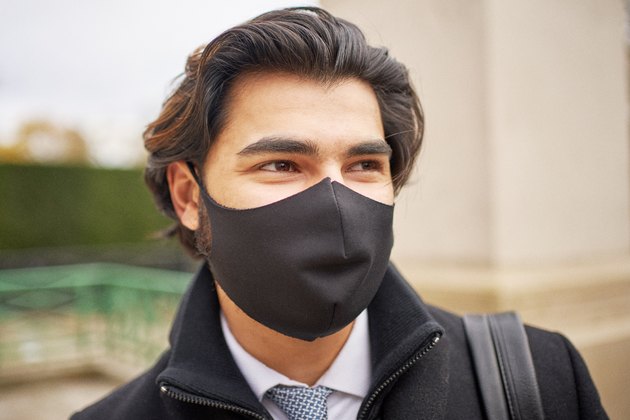 A portrait of a smart young man wearing a protective face mask