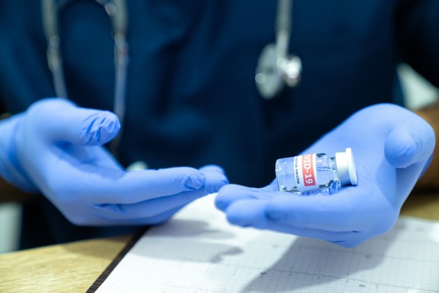 Close-Up Of Doctor is introducing Medical Injection for covid-19 vaccines