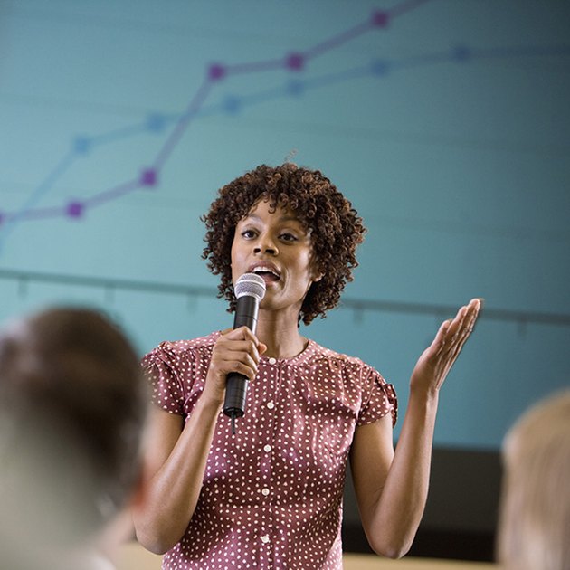 Woman asking a question at an informational meeting