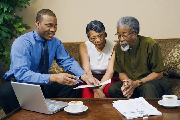 Couple with businessman discussing finances