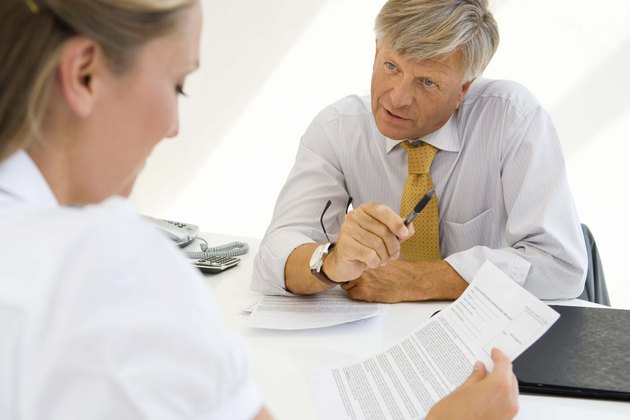Woman with document and financial adviser