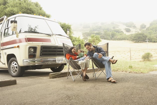 Family sitting by truck outdoors