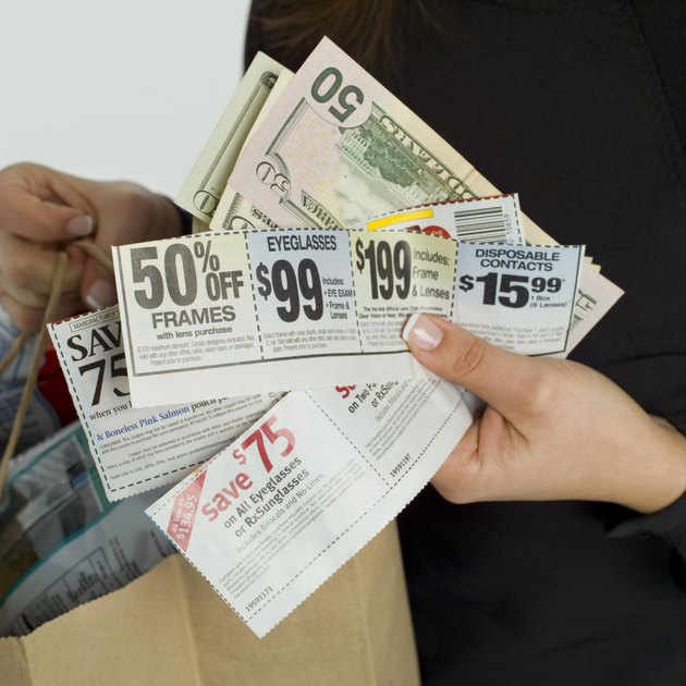 Woman with coupons, money and groceries