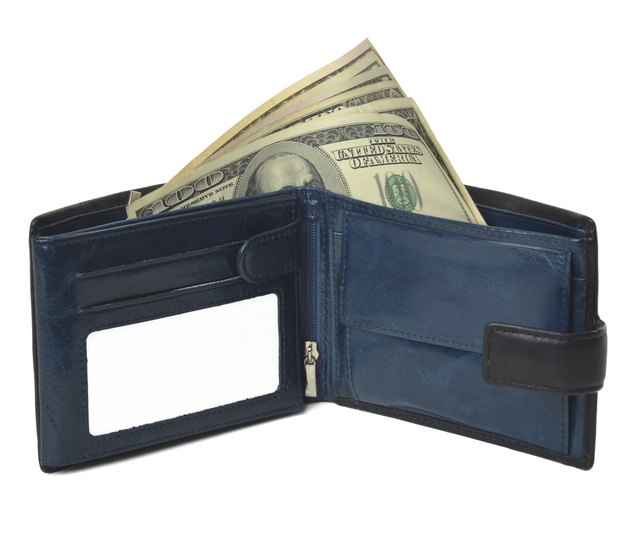 Blue purse with moneys (dollars) isolated on white background.