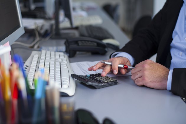 Businessman using calculator