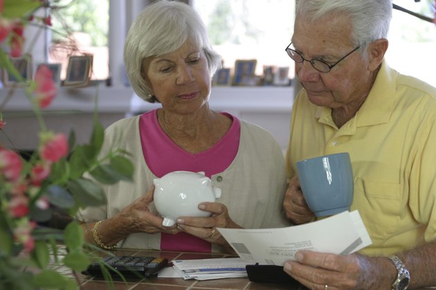 Close-up of a senior couple reading a bill