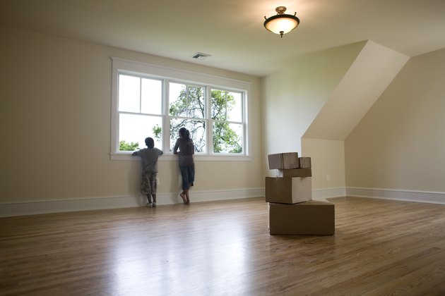 Kids looking out window of empty room