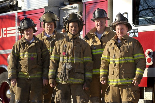 Firefighters standing near fire truck