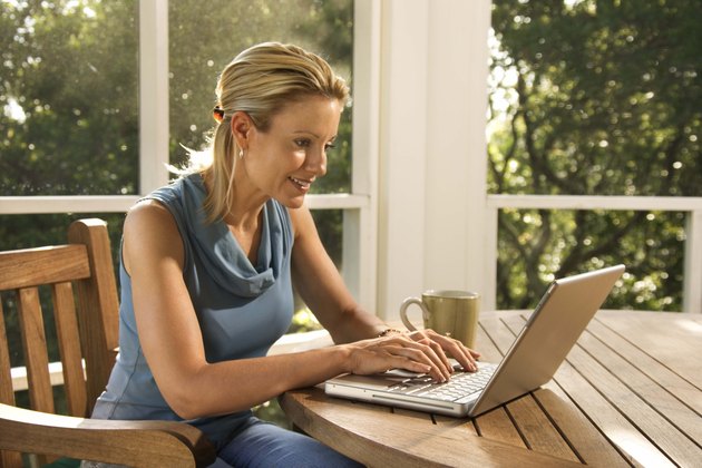 Woman on porch with laptop computer