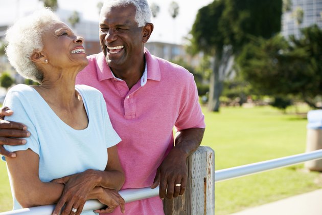Senior Couple Walking In Park Together