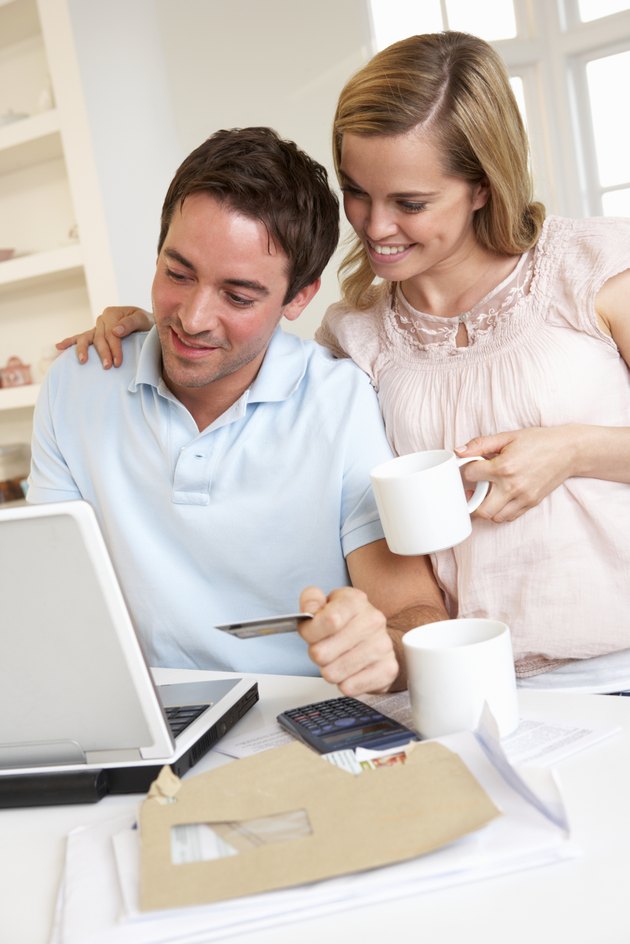 Young couple using credit card on the internet