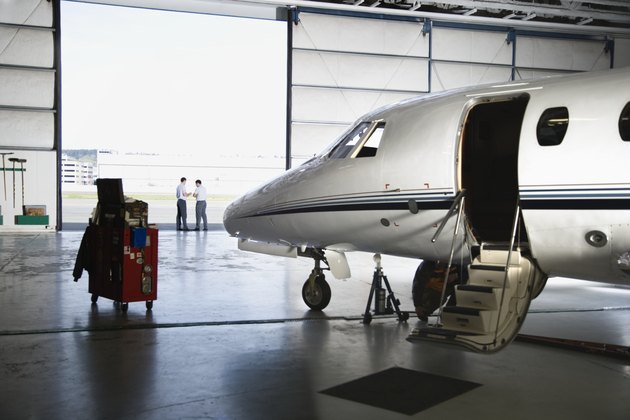 Airplane in hangar with men in background