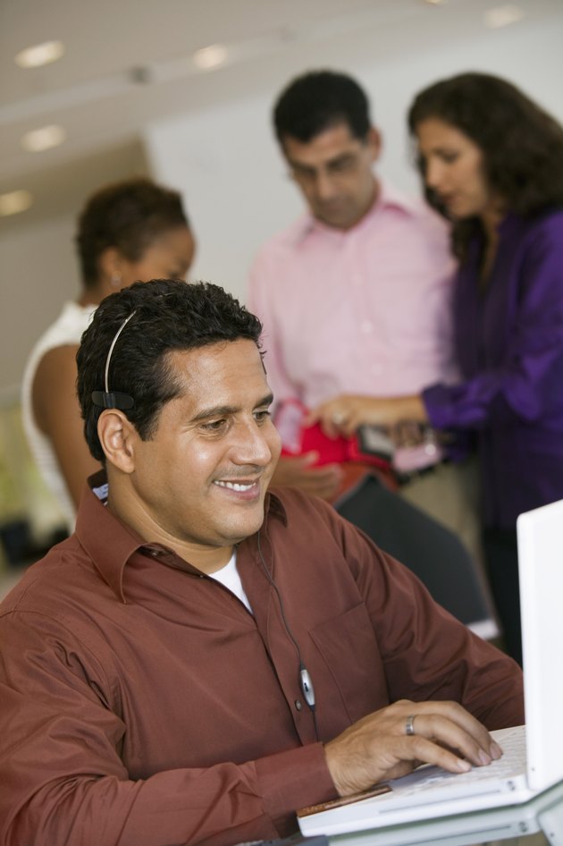 Man on Computer and Shopping Couple