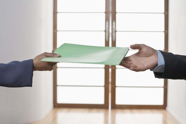 Hands of people exchanging folder