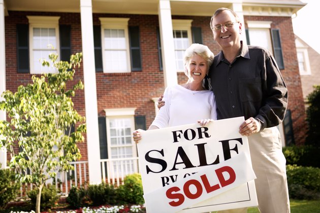 Couple with sold sign