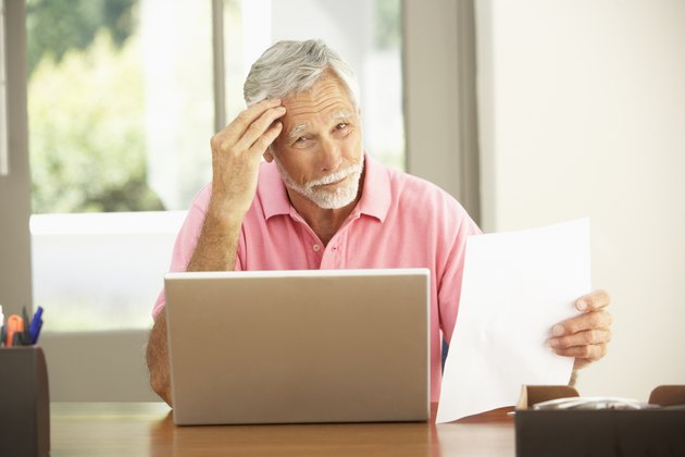 Senior Man Using Laptop At Home