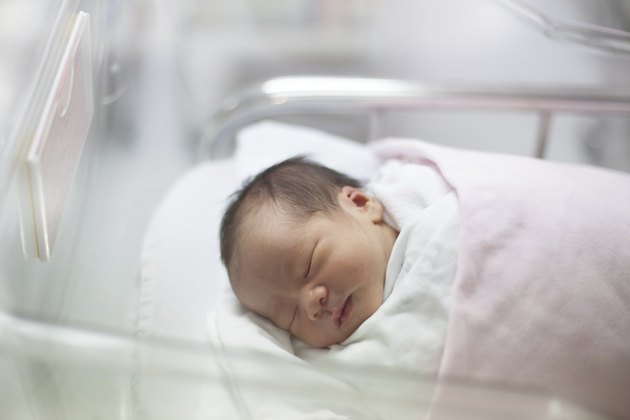 face of first day new born in hospital delivery room