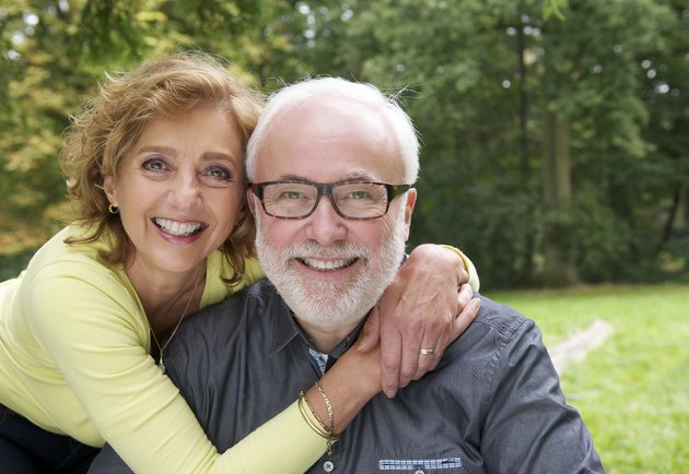 Happy married couple smiling together outdoors