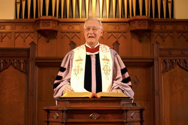 A minister giving a sermon at the pulpit in church.
