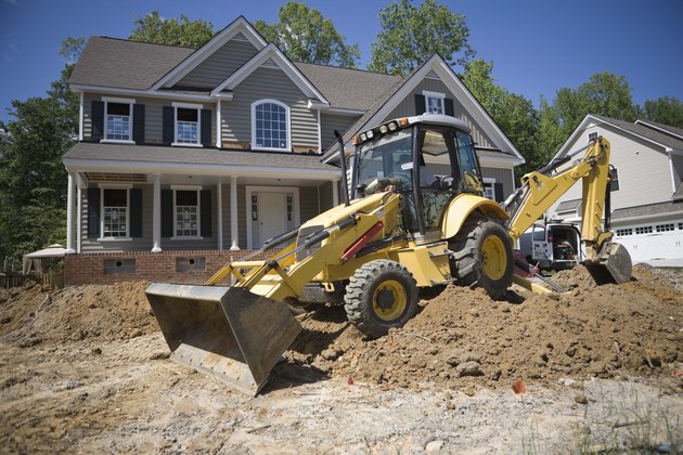 Exterior of unfinished house with tractor