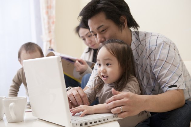 Father and Daughter Looking at PC