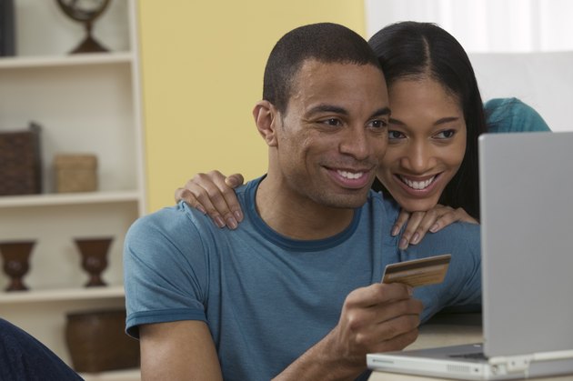 Couple with credit card on laptop